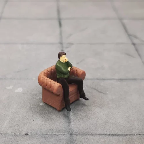 Seated man talking on the phone in 1/64 scale