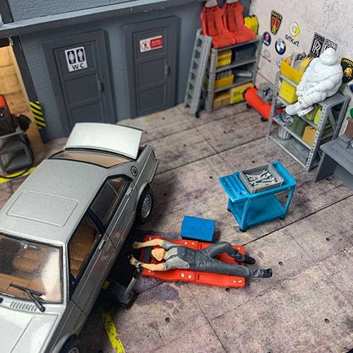 1-43 garage diorama mechanic figure on a Torin Rolling creeper with a wrench